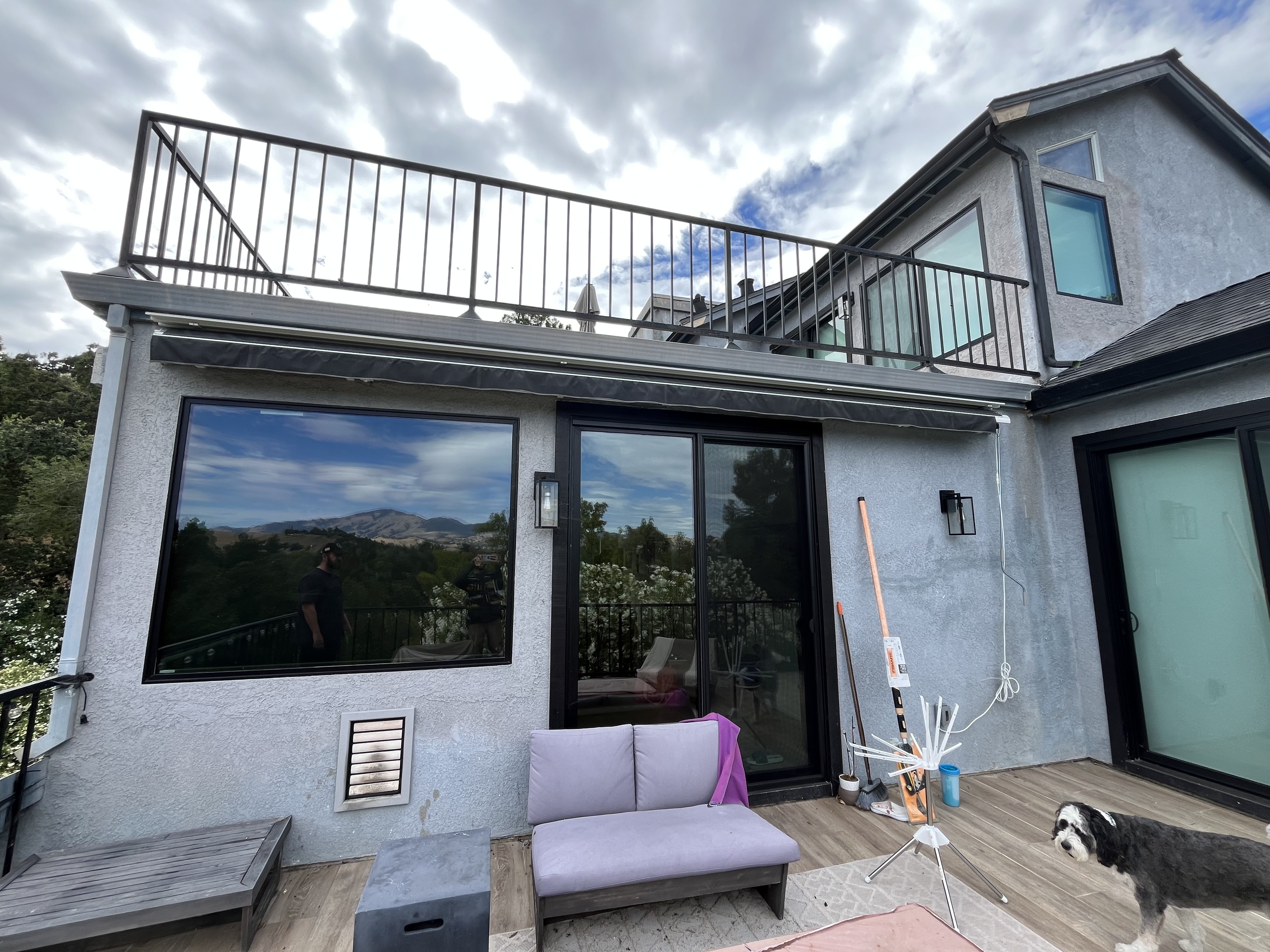Retractable awning installed over a back patio deck
