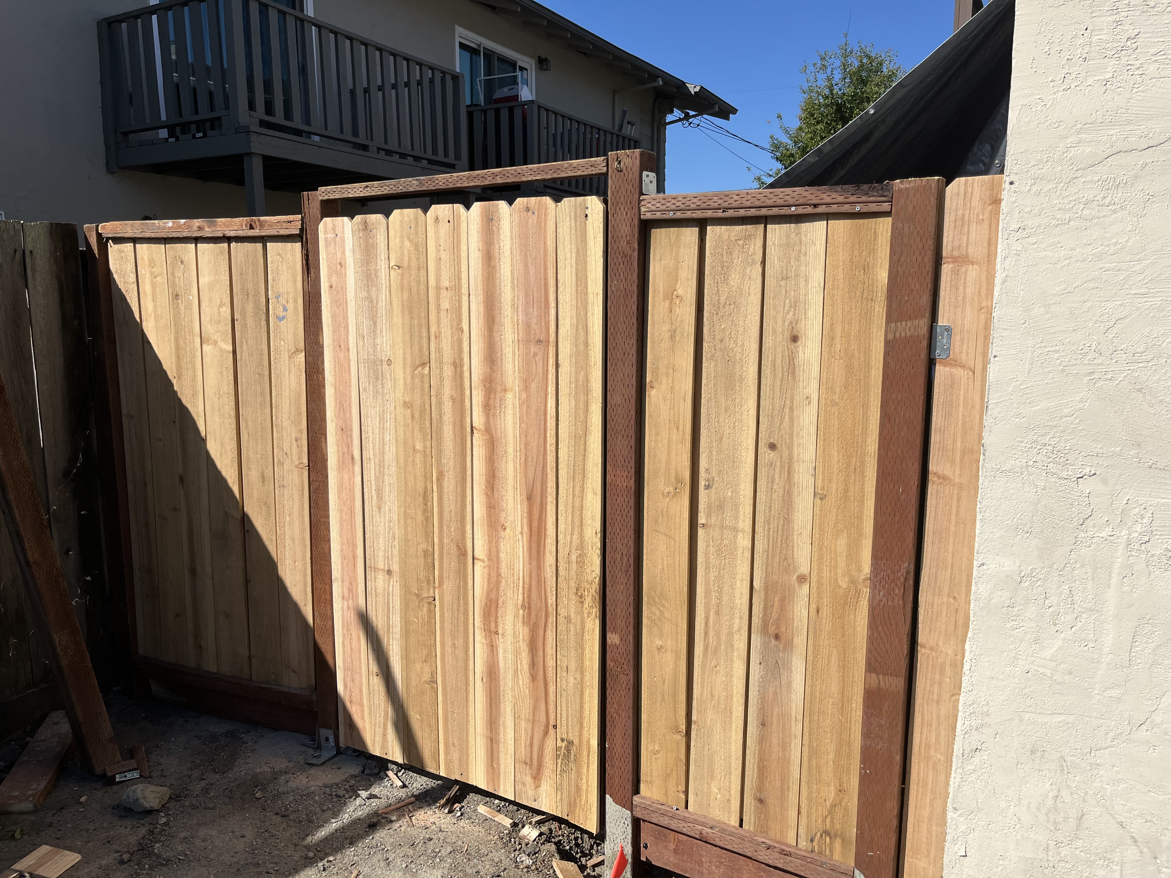 New cedar wood fence installation with gate