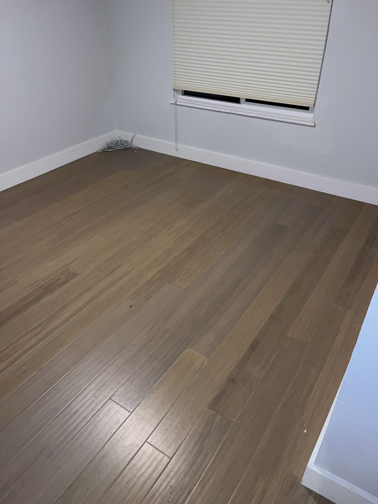 Bamboo hardwood flooring installed across a bright room