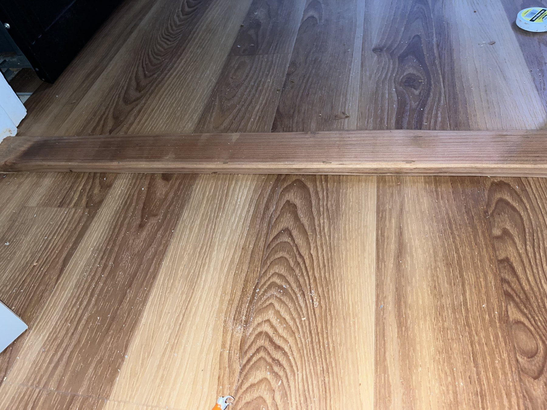 Light vinyl plank flooring installed in a bedroom with ceiling fan