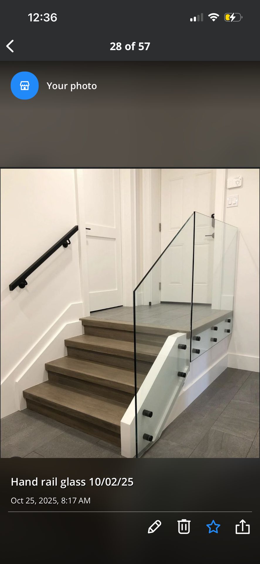 Glass railing system with metal posts along a landing