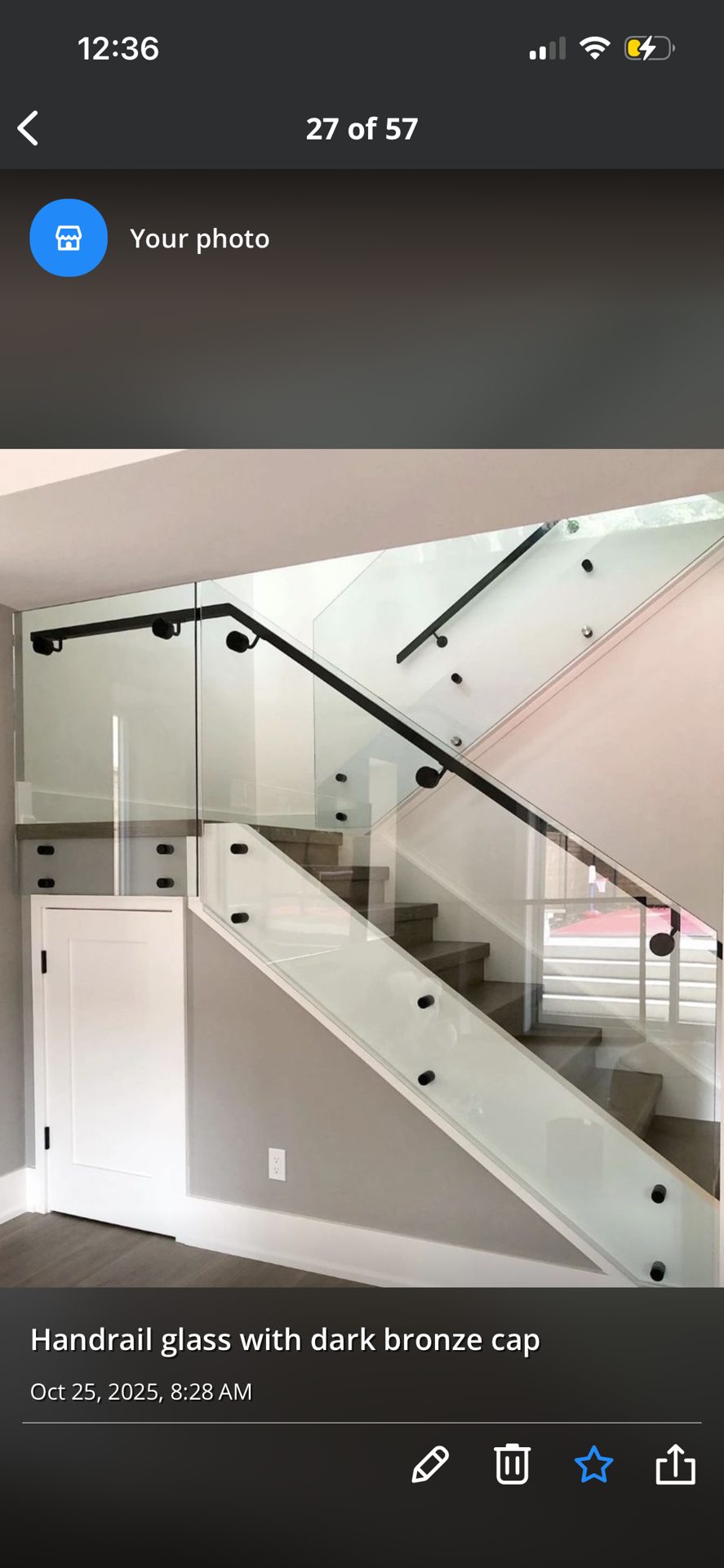 Glass handrail installation with a dark bronze cap on a staircase