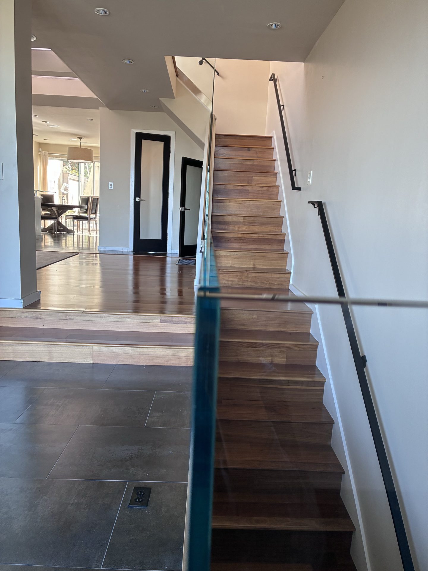 Frameless glass railing running along a staircase