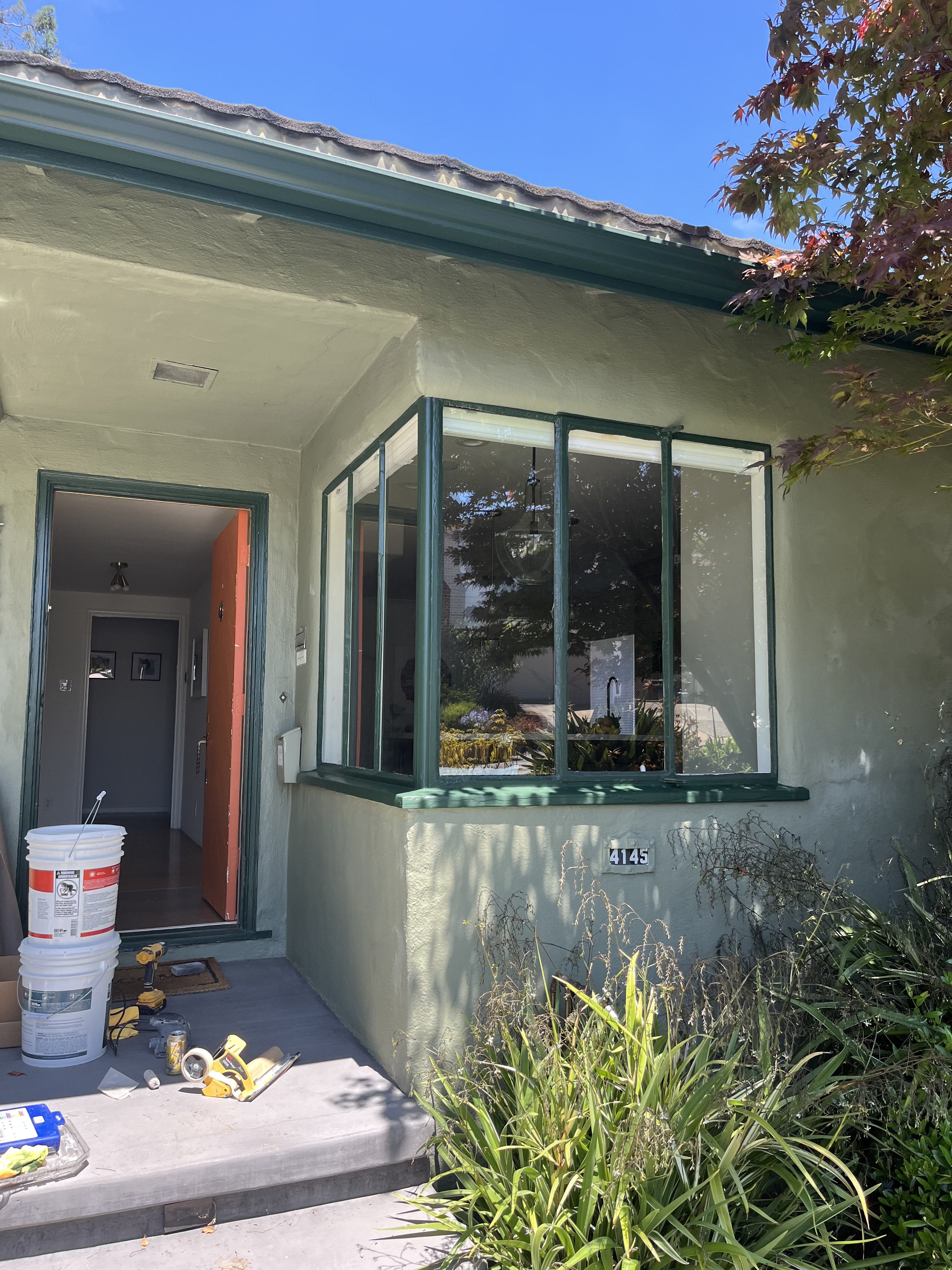 New bay window installed on a green stucco home